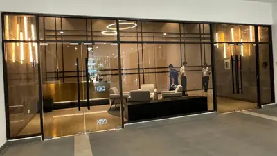 a glass lobby with people standing in a building at KL Premium Dual Key Studio with KLCC view on the 56th floor in Kuala Lumpur