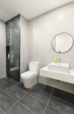 a bathroom with a toilet and a sink and a mirror at KL Premium Dual Key Studio with KLCC view on the 56th floor in Kuala Lumpur