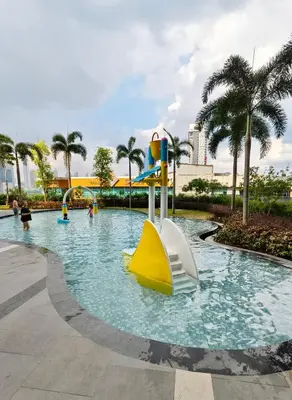 a pool at a resort with a slide at KL Premium Dual Key Studio with KLCC view on the 56th floor in Kuala Lumpur