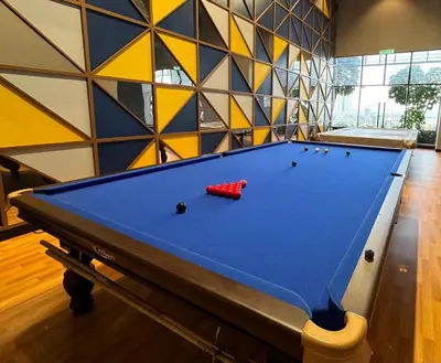a pool table in a room with a wall at KL Premium Dual Key Studio with KLCC view on the 56th floor in Kuala Lumpur
