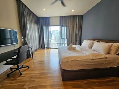 a bedroom with a bed and a desk and a television at Resort Style Haven 3BR6pax St Mary KLCC Twin Towers View in Kuala Lumpur