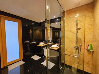 a bathroom with two sinks and a shower with a glass door at Resort Style Haven 3BR6pax St Mary KLCC Twin Towers View in Kuala Lumpur
