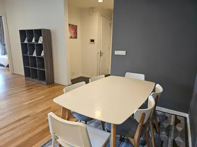 a dining room with a white table and chairs at Resort Style Haven 3BR6pax St Mary KLCC Twin Towers View in Kuala Lumpur
