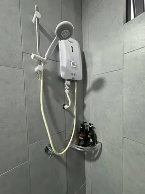 a shower with a blow dryer in a bathroom at PavKlccTrxVelo ,MrtLrt ,13PAX ,4R2B ,Free KLCCPavTRXVelocity X MrtLrt X 13PAX X 4R2B X Free 4CPark in Kuala Lumpur