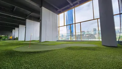 a golf course in a building with large windows at Opus Residences Kuala Lumpur by Infini Suites in Kuala Lumpur