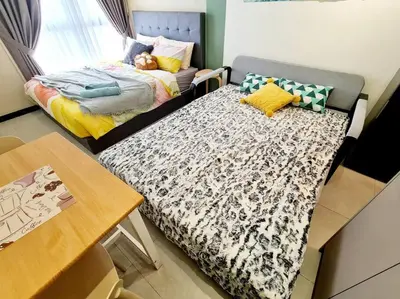a small room with a bed and a table at Neu Suites Near Gleneagles 10 minutes to KLCC in Kuala Lumpur