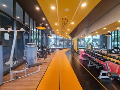 a gym with rows of treadmills and machines at Neu Suites Near Gleneagles 10 minutes to KLCC in Kuala Lumpur
