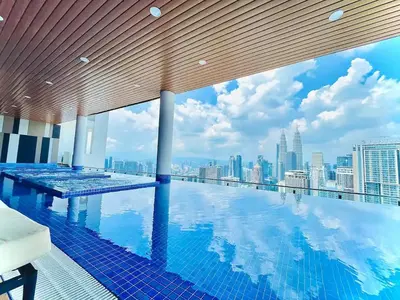a swimming pool with a view of the city at Maxhome Cozy at The Luxe in Kuala Lumpur