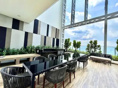 a restaurant with tables and chairs and a large window at Maxhome Cozy at The Luxe in Kuala Lumpur