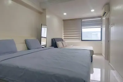 a bedroom with a large bed and two chairs at Fahrenheit 88, Bukit Bintang 10 in Kuala Lumpur
