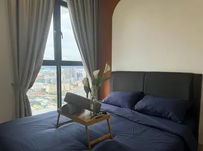 a bedroom with a blue bed with a window at TRION KL, KLCC TRX IKEA at Chan Sow Lin, Kuala Lumpur by ONE Guesthouse in Kuala Lumpur