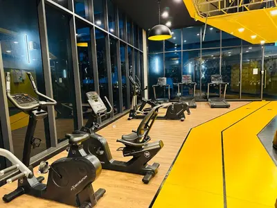 a gym with a row of exercise bikes and treadmills at Neu Suites Service Apartment By Moonlight in Kuala Lumpur