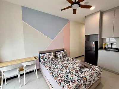 a bedroom with a bed and a table and a kitchen at Neu Suites Service Apartment By Moonlight in Kuala Lumpur
