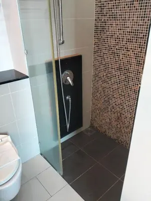 a bathroom with a shower with a toilet at Star Suites At Swiss Garden Residences in Kuala Lumpur