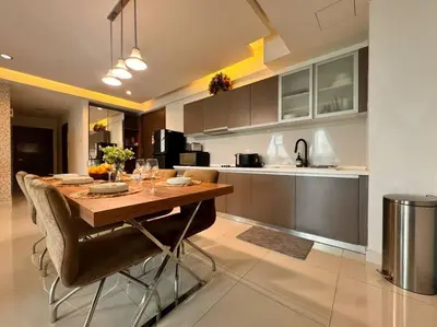 a kitchen with a wooden table and chairs in a room at Immersed in the warmth and natural ambience in Kuala Lumpur