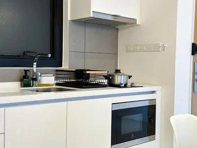 a kitchen with a sink and a stove top oven at 5 pax - Bangsar South - 7 mins drive to Mid Valley in Kuala Lumpur