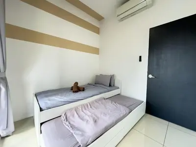 a bedroom with two bunk beds and a black door at 5 pax - Bangsar South - 7 mins drive to Mid Valley in Kuala Lumpur