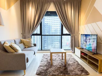 a living room with a couch and a large window at 5 pax - Bangsar South - 7 mins drive to Mid Valley in Kuala Lumpur