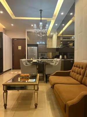 a living room with a couch and a table at Super suite at Dorsett residence bukit bintang kl in Kuala Lumpur