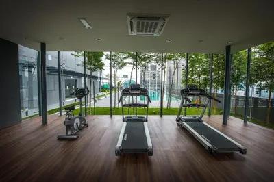 a gym with three treadmills and a large window at Super suite at Dorsett residence bukit bintang kl in Kuala Lumpur