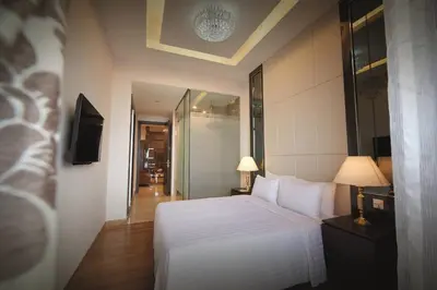 a bedroom with a white bed and a television at Super suite at Dorsett residence bukit bintang kl in Kuala Lumpur