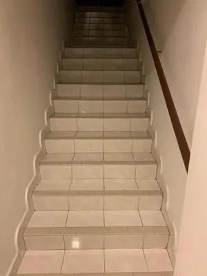 a staircase with white tile floors and a stair case at Cityscape KL in Kuala Lumpur