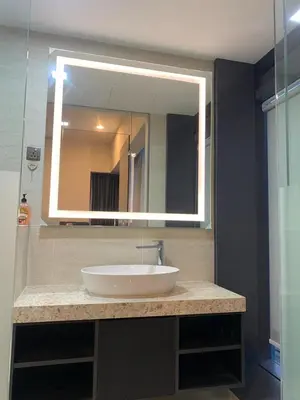 a bathroom with a sink and a large mirror at Holiday Suites Star Residences in Kuala Lumpur