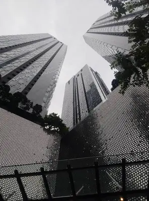two tall skyscrapers in a city with a fence at Holiday Suites Star Residences in Kuala Lumpur