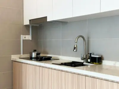 a kitchen with a sink and a stove top oven at 2B2B Cozy - 5 min to PWTC - Sentul KL in Kuala Lumpur