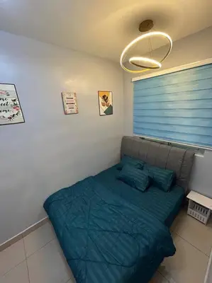 a bed in a bedroom with a blue blanket at Setapak KL Apt 3 Room 8 pax in Kuala Lumpur