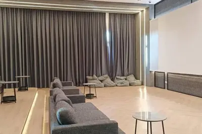 a living room with couches and tables and a screen at Setapak KL Apt 3 Room 8 pax in Kuala Lumpur