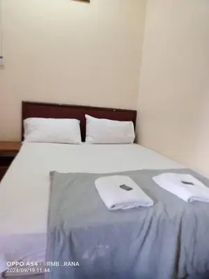 a bedroom with a bed with two towels on it at perfect class hotel in Kuala Lumpur