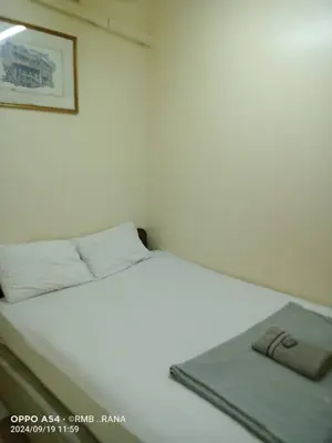 a white bed with a mirror on top of it at perfect class hotel in Kuala Lumpur