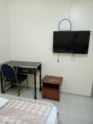 a bedroom with a desk and a tv on the wall at perfect class hotel in Kuala Lumpur