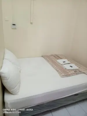 a white bed with a blanket on top of it at perfect class hotel in Kuala Lumpur