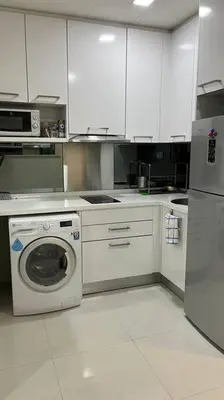 a kitchen with a washing machine and a refrigerator at KL City Centre in Kuala Lumpur