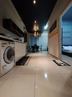 a living room with a washing machine and a table at apartment for classic lover in Kuala Lumpur