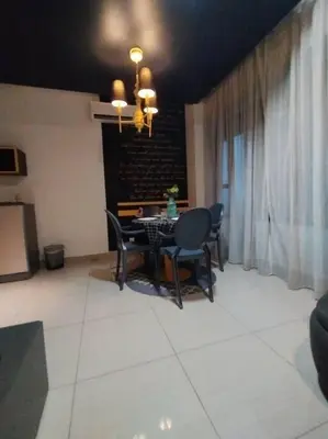 a dining room with a table and chairs at apartment for classic lover in Kuala Lumpur