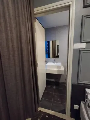 a bathroom with a shower curtain and a sink at apartment for classic lover in Kuala Lumpur