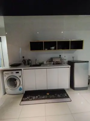 a kitchen with a sink and a washing machine at apartment for classic lover in Kuala Lumpur