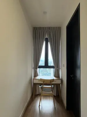 a table and a chair in a room with a window at Modern Luxury Apartment, Sunway, TRX in Kuala Lumpur