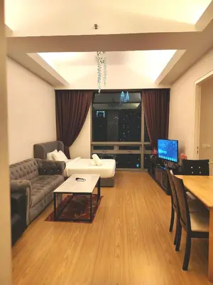 a living room with a couch and a table at Swiss Garden Residence by Offex Suites KL in Kuala Lumpur