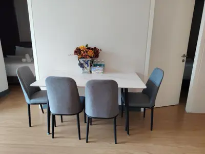 a table with chairs and a vase of flowers on it at Swiss Garden Residence by Offex Suites KL in Kuala Lumpur