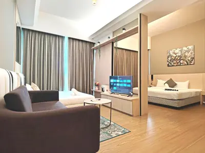 a living room with a couch and a television at Swiss Garden Residence by Offex Suites KL in Kuala Lumpur
