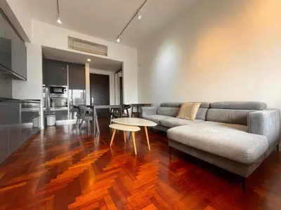 a living room with a couch and a table at The Mews KLCC by PILLOWTALKS in Kuala Lumpur