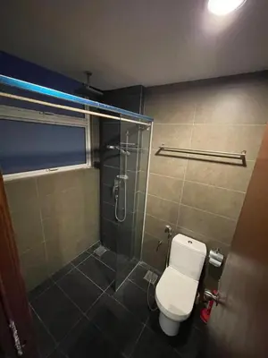 a bathroom with a toilet and a glass shower at cozy 3 bedroom 6PAX setapak central mall in Kuala Lumpur