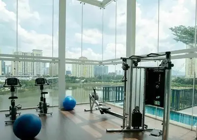 a gym with several exercise bikes and a large window at cozy 3 bedroom 6PAX setapak central mall in Kuala Lumpur