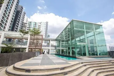 a glass building with a pool in front of it at Phenomenal atmosphere 4 PAX setapak central mall in Kuala Lumpur