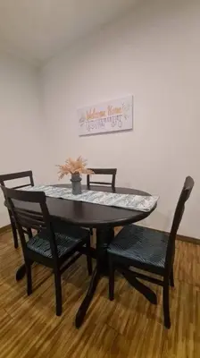 a dining room table with four chairs and a table and a picture at Phenomenal atmosphere 4 PAX setapak central mall in Kuala Lumpur