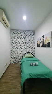 a bedroom with a green bed in a room at Cozy studio family lake view SETAPAK CENTRAL MALL in Kuala Lumpur